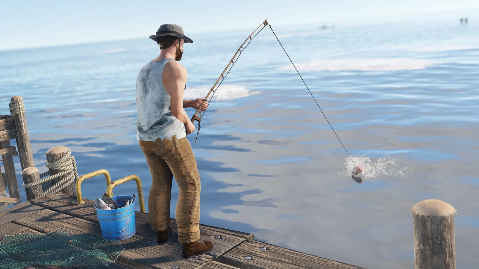 A player fishing from a dock with a bucket of fish beside them