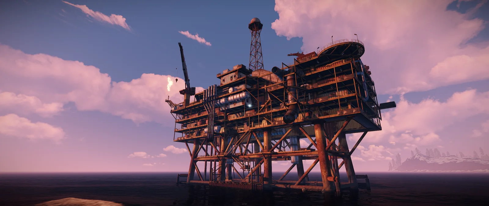 Large Oil Rig at dusk, decks stacked above the water with its helipad on top