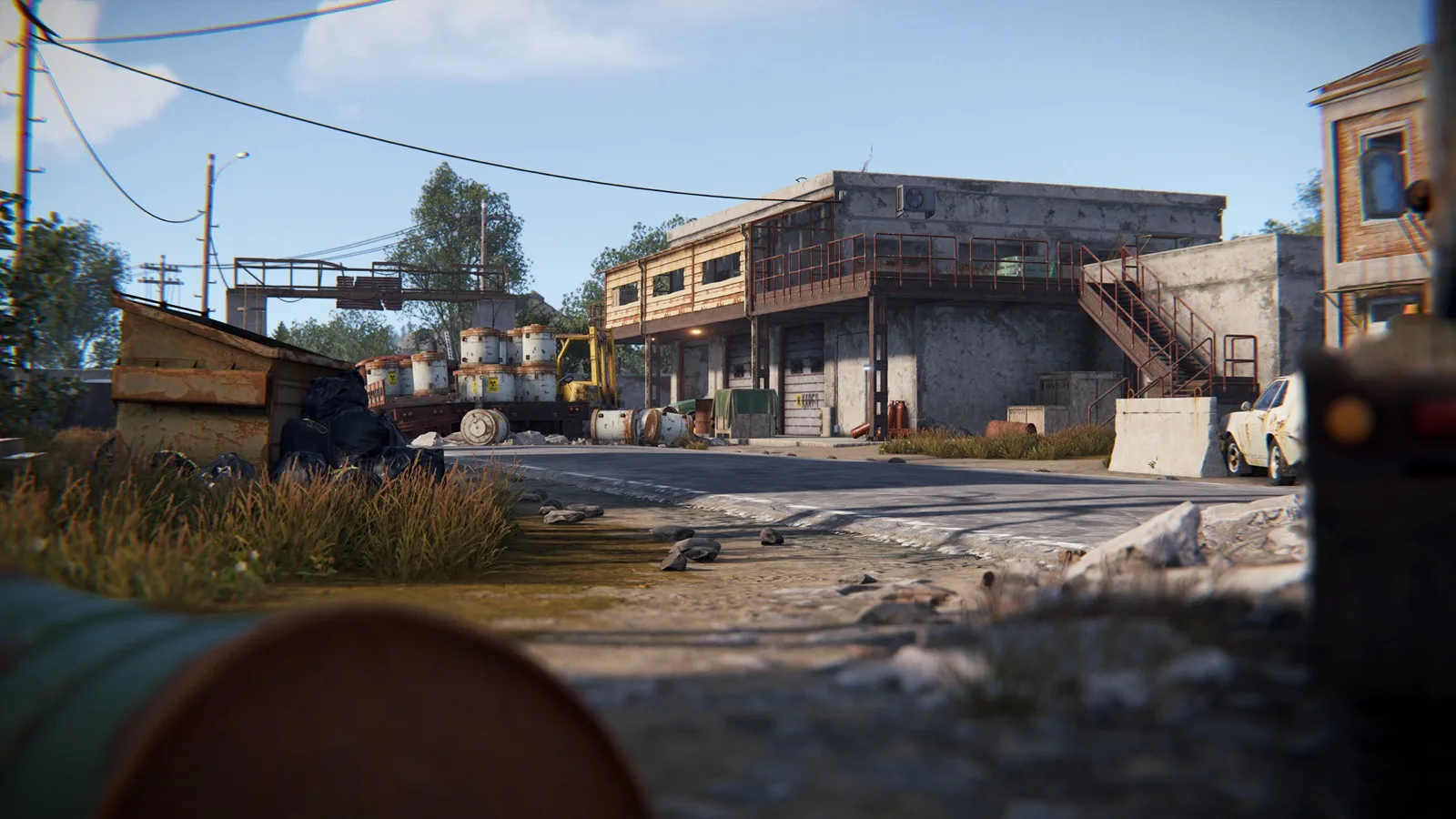 Radtown's ruined street lined with radioactive barrels and concrete buildings
